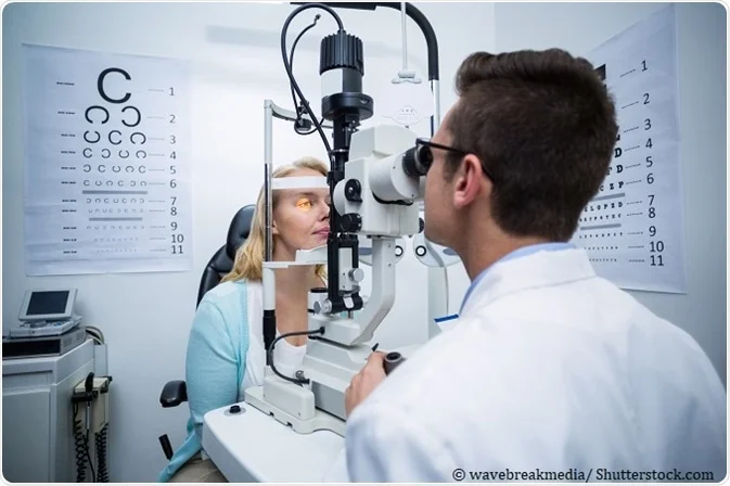 This picture represents an optometrist examining his patient